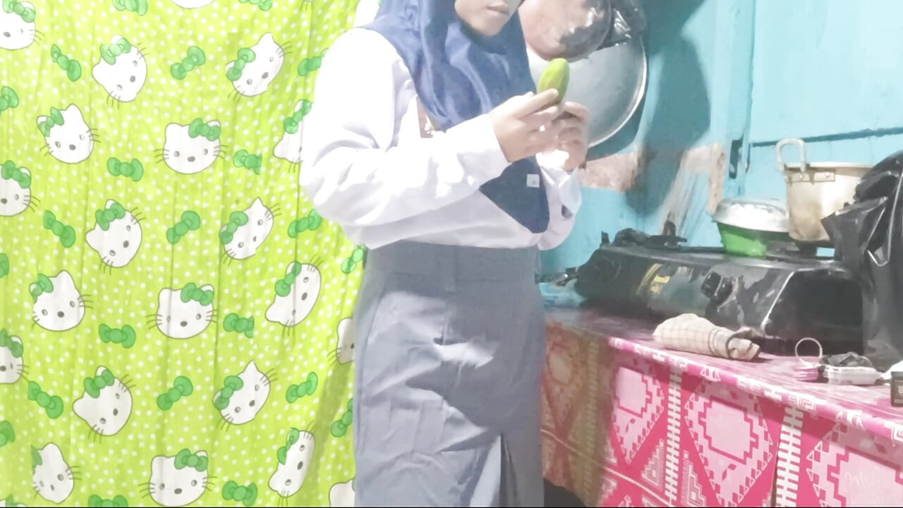 School girl masturbates in the kitchen using cucumbers
