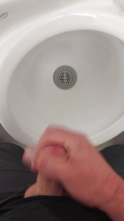 Moaning daddy has a lot of pressure and milks his cock in the public toilet