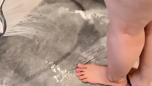 Anong Cleans the Bathroom Floor with Her Soaked Hoodie, on Her Knees.
