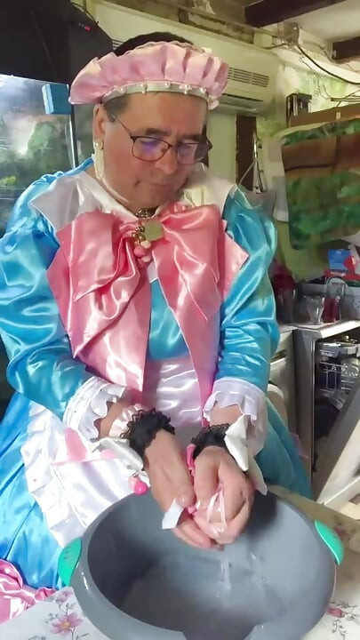 In a blue maid's outfit with pink bows to do the laundry.