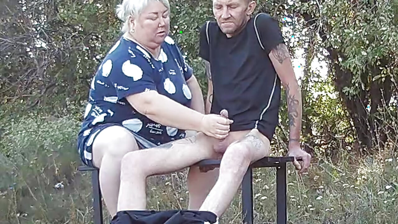 a friend in a public park jerks off my dick on a bench