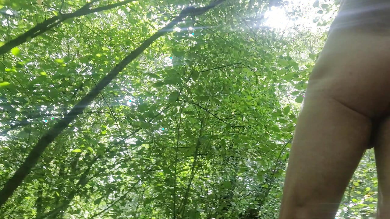 Naked guy walking in the woods