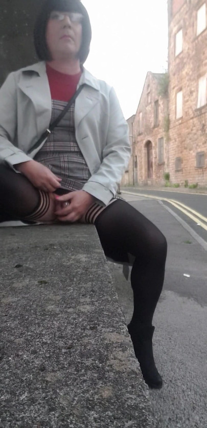Stunning moment from "Crossdressing slut exposes her caged cock on public street"