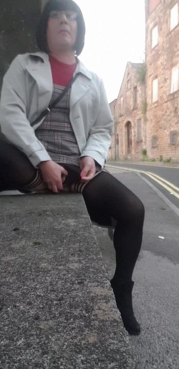 Stunning moment from "Crossdressing slut exposes her caged cock on public street"