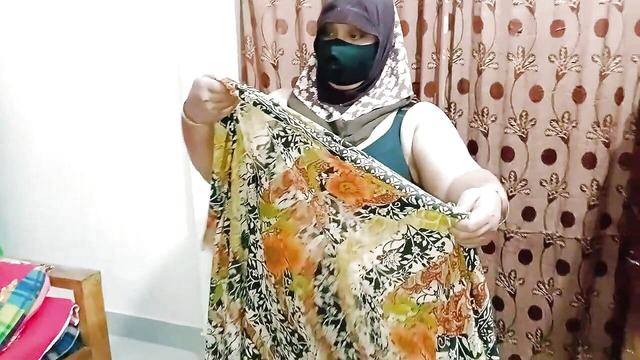 Hijabi girl takes off her clothes and wears a saree. Those big breasts are visible.
