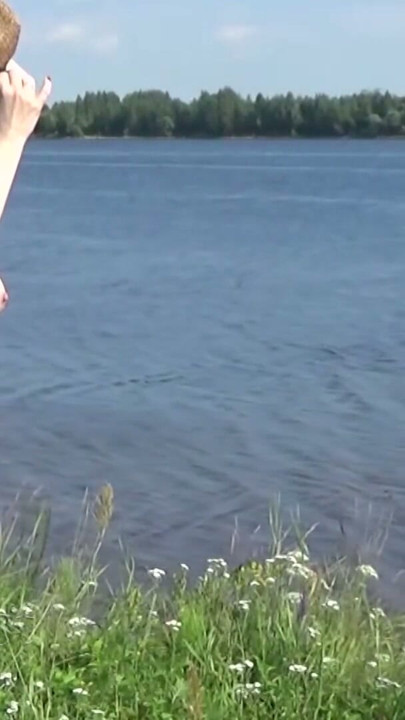 Beautiful naked walk in the wild: Naturist posing in a green spring field | Clip 1