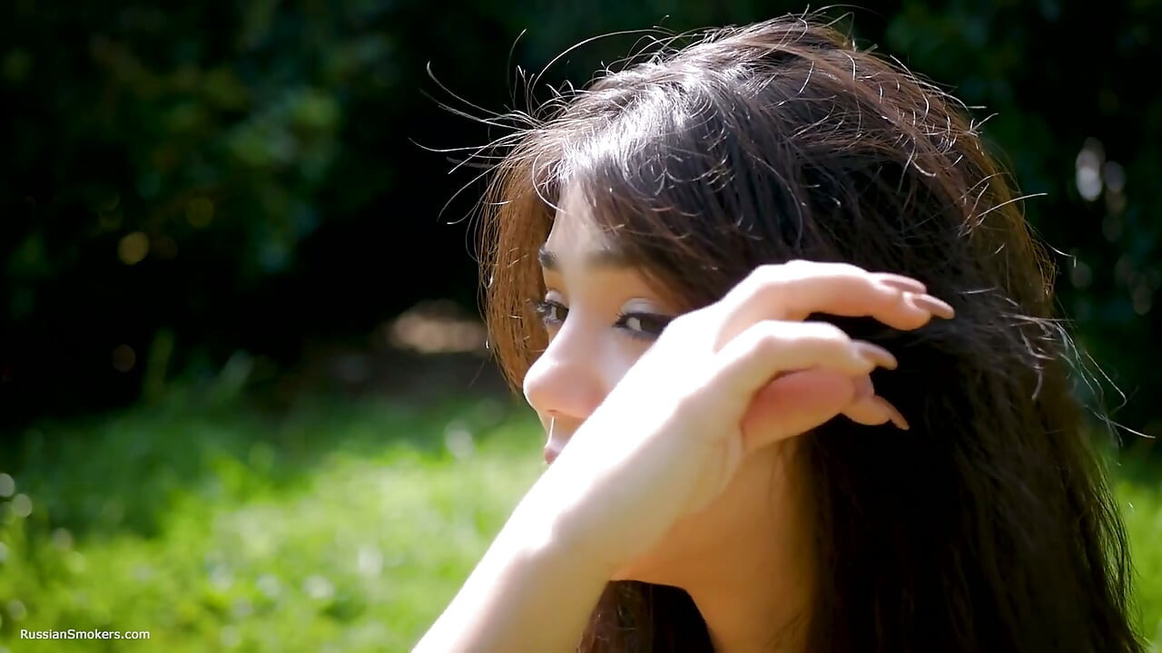 Arina Is Smoking One Black Cigarette Outdoors