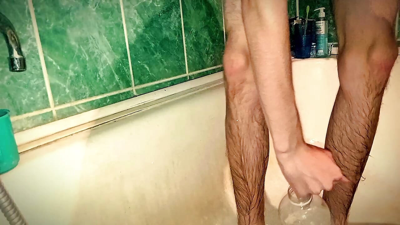 Twink fucked a bottle in the bathroom. Skinny guy jerking off with a bottle in his bathroom