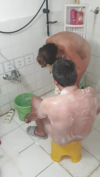 Old man bathing with his young girlfriend, Turkish couple in their natural home life.