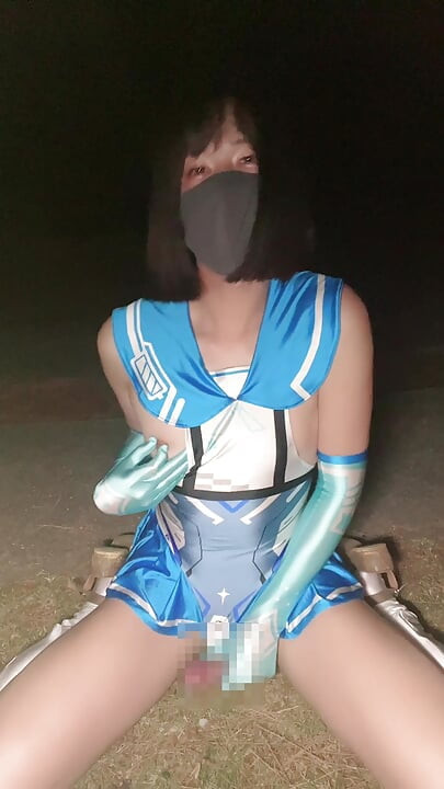Sailor uniform-style cosplay crossdressing in the park