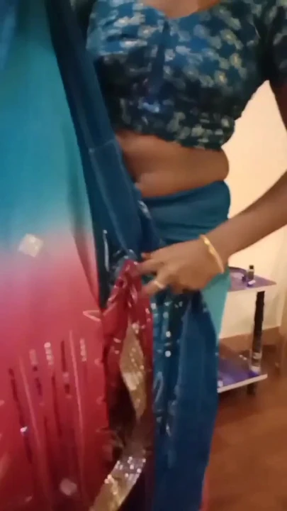 Key moment from "Desi Indian Tamil Hotwife Teases Sugar Daddy in Pink Bra and Saree with Navel Show at Hotel!"