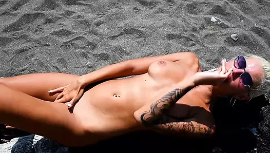 This busty lustful bitch sucks candy on the beach and dreams of a big dick in her juicy pussy