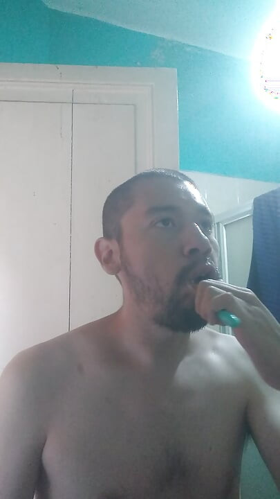 Handsome man washes his face