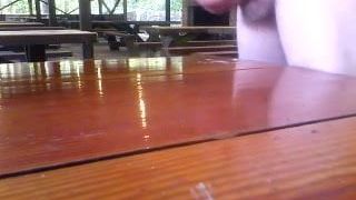 Cumming on a picnic table at work