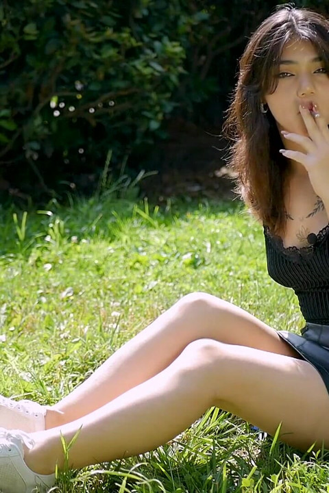 Arina Is Smoking One Black Cigarette Outdoors