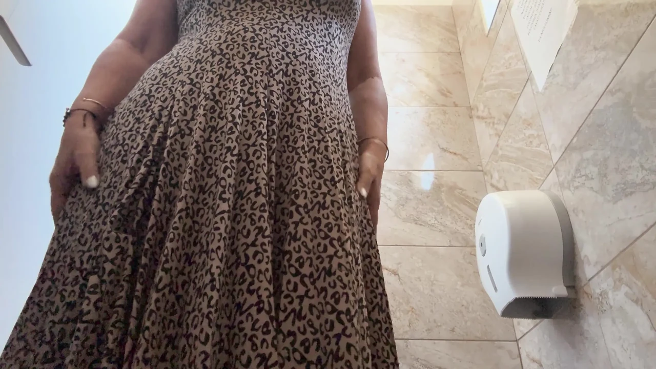 A horny mature MILF is very aroused and is rubbing her pussy in the public restroom at the office.