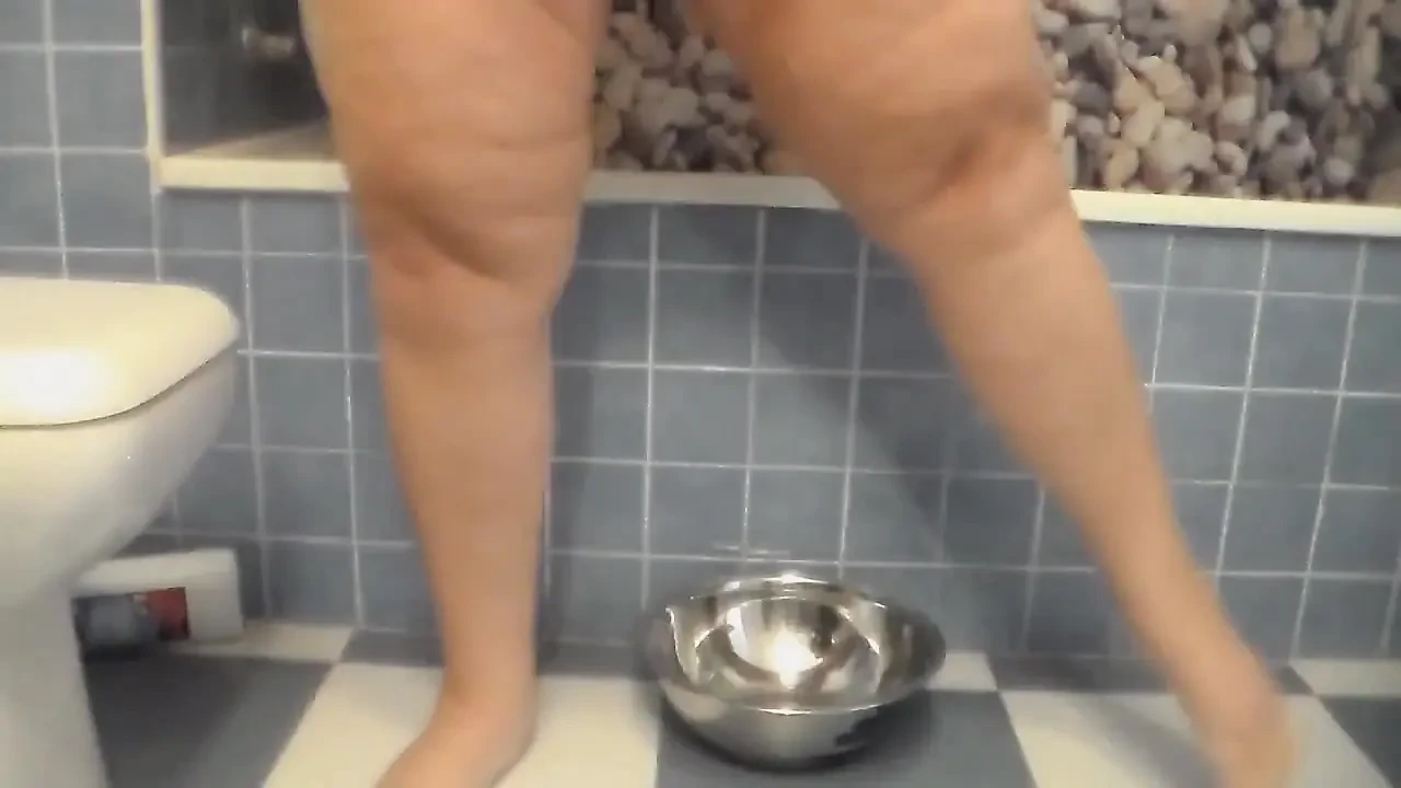 Jen is peeing all into a steel bowl
