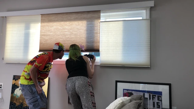 Couple Peeping Outside Apartment Window