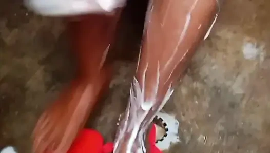 Getting a bath in traditional bathroom in village.