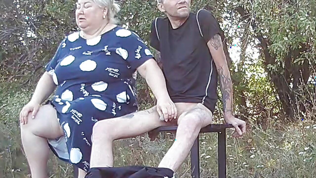 a friend in a public park jerks off my dick on a bench
