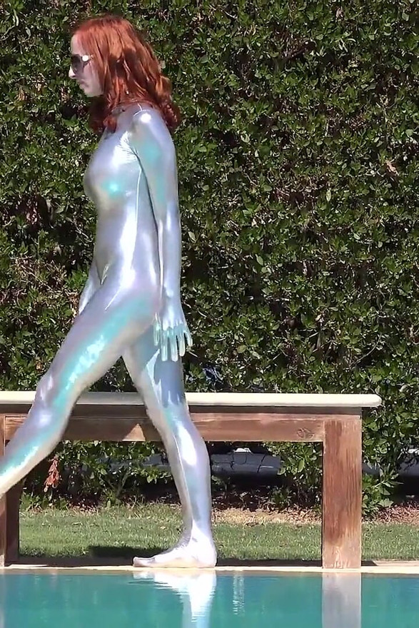 Bending in a Silver Spandex Suit