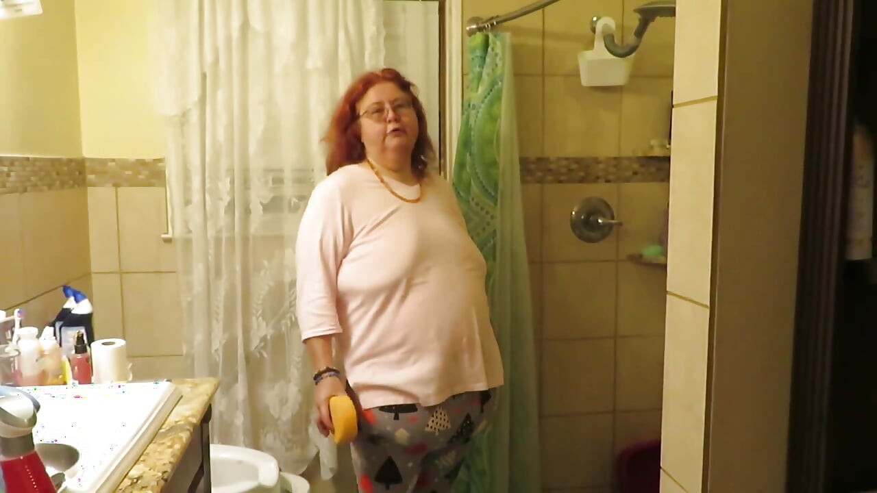 Step mom cleaning bathroom thinks of her step son watching