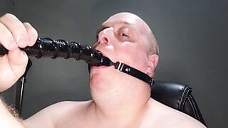 Deepthroating an 18 inch dildo with mouth gag ring