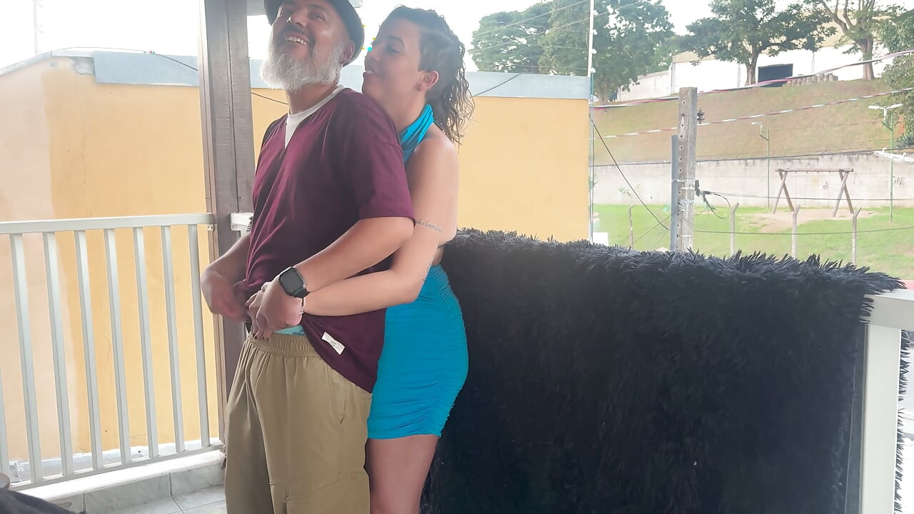 Strangers making out on a balcony during the party.