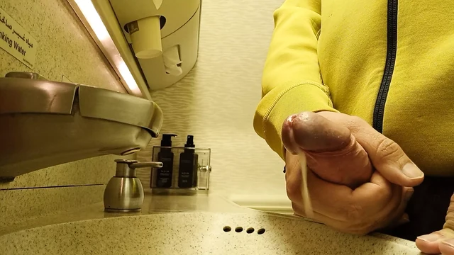 Wanking in an airplane toilet, close up