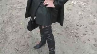 Leather slut with buttplug outside