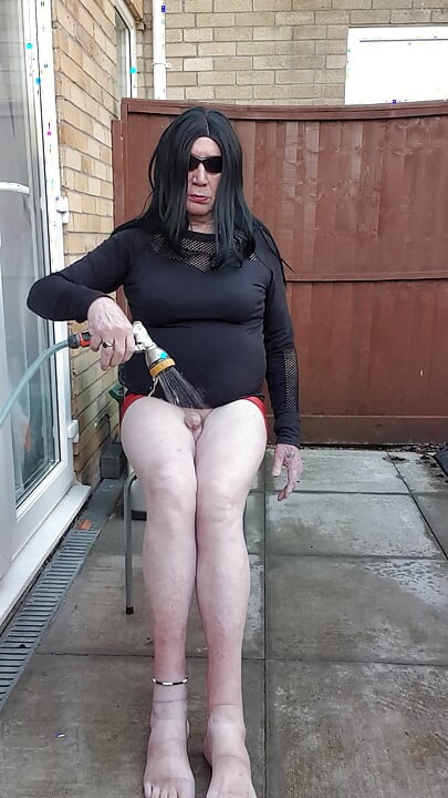 Dressed Gurl Spraying Her Bare Legs With Ice Cold Water