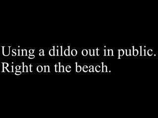 Using a dildo on the beach.