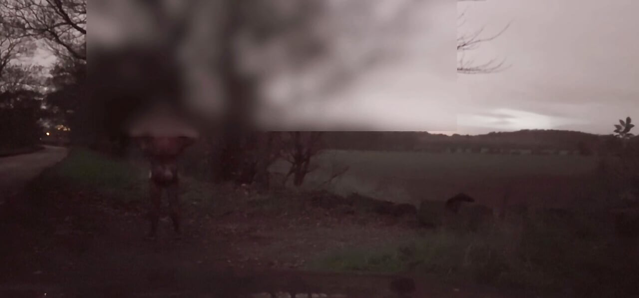 Wanking  in body stocking dodging cars that pass by