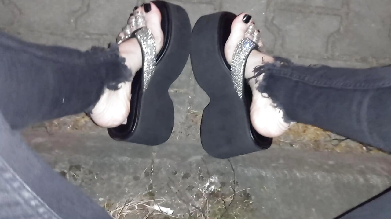 I wear platform flip-flops and tight jeans, showing off my feet.