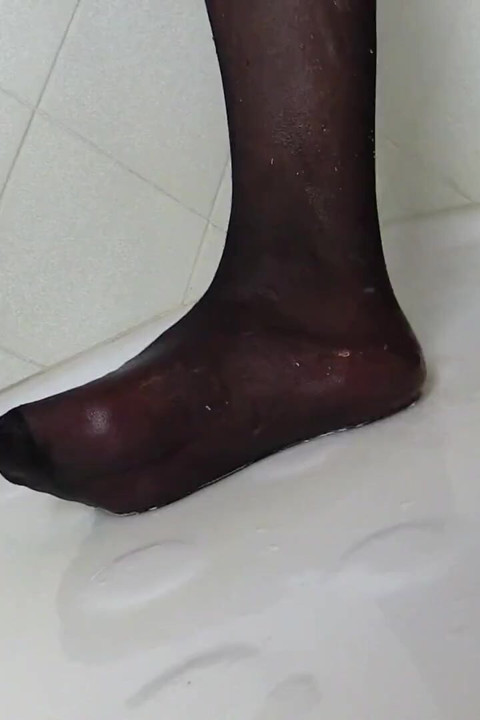 Redhead tranny in sexy stockings  pissing on feet in the bathroom