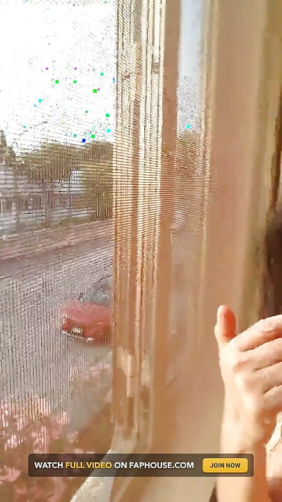 窓の前で、窓を開けて