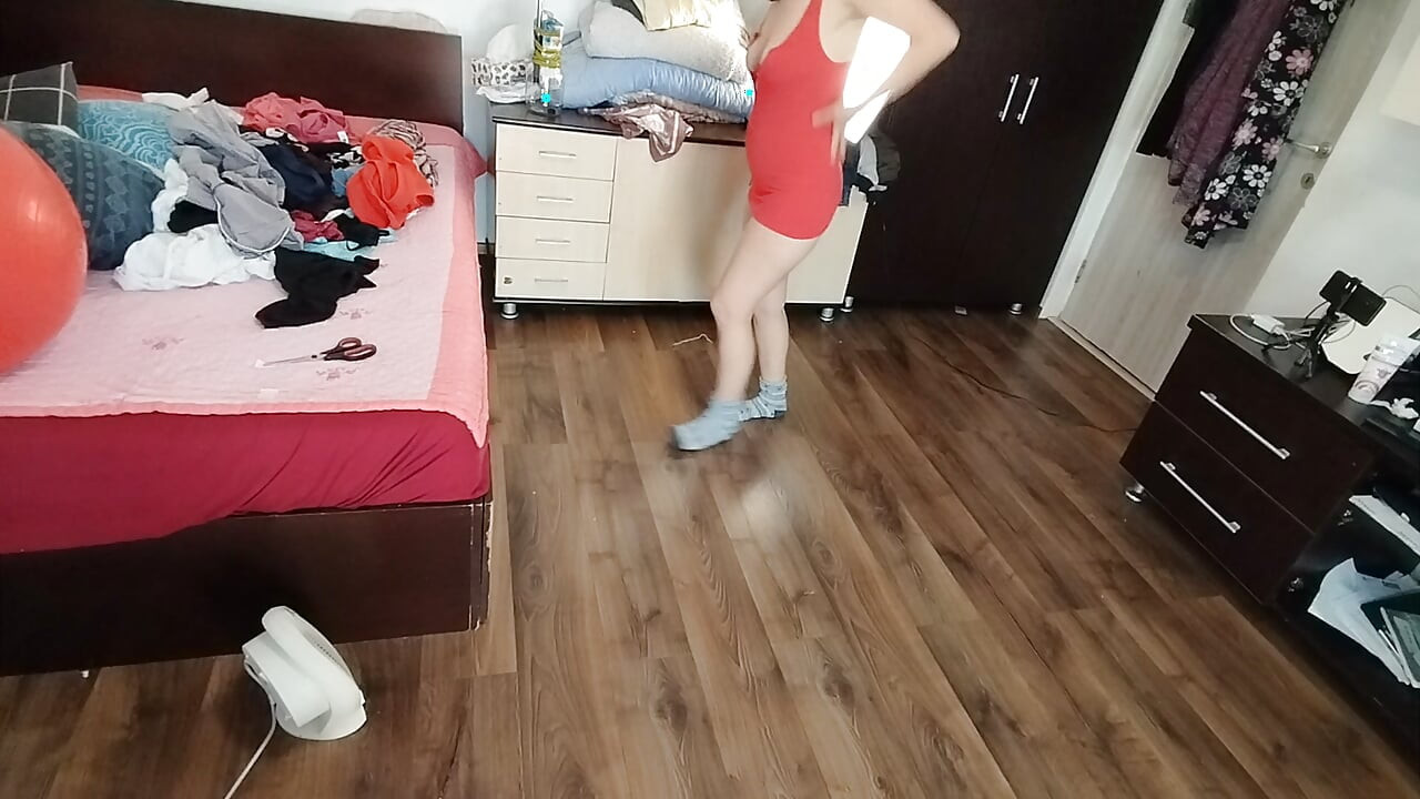 Amateur woman has fun trying on clothes and cutting them.