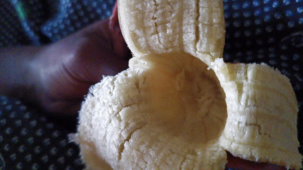 Indian Young boy eating banana at private room