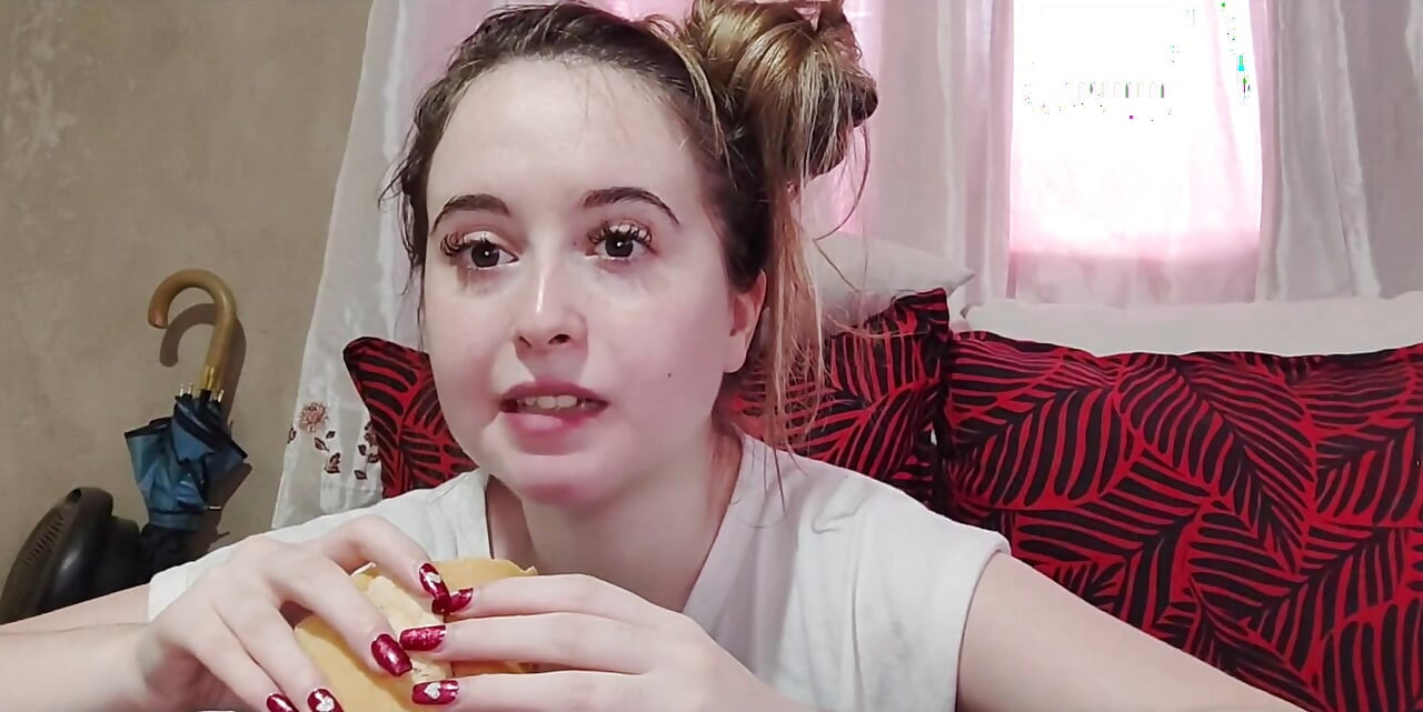 Eating an omelette sandwich with cherry tomatoes