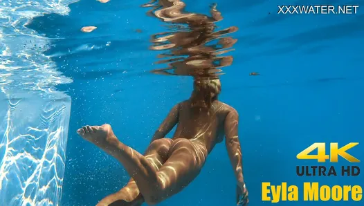 Eyla Moore, a famous model, glides elegantly through the water