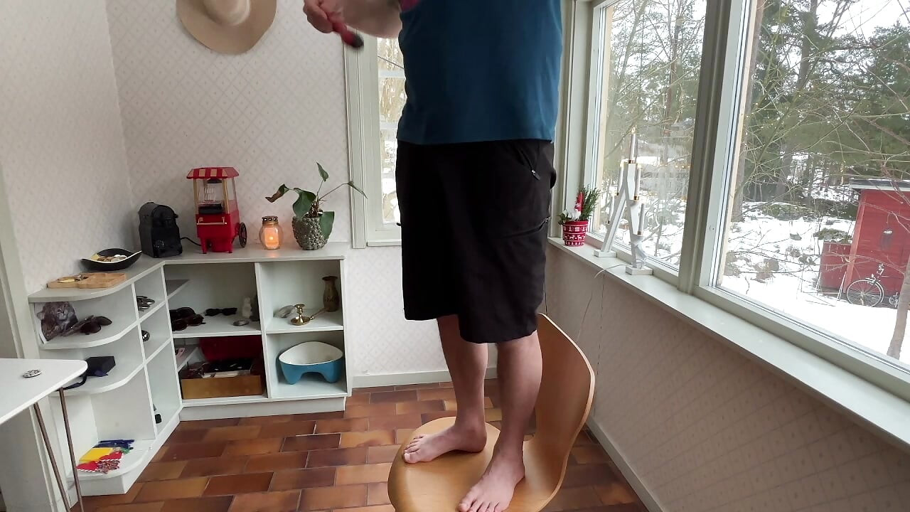 Wife interrupts husband as he does some electricity work in the kitchen