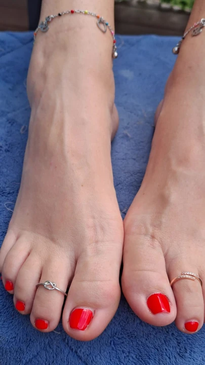 Cute little size 7 US feet teasing me with red nail polish, toe rings and anklets.