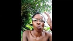 Jong zwart meisje dat in de tuin masturbeert
