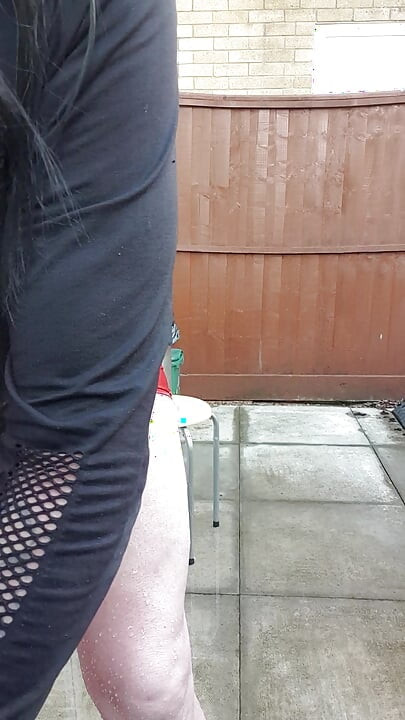 Dressed Gurl Spraying Her Bare Legs With Ice Cold Water