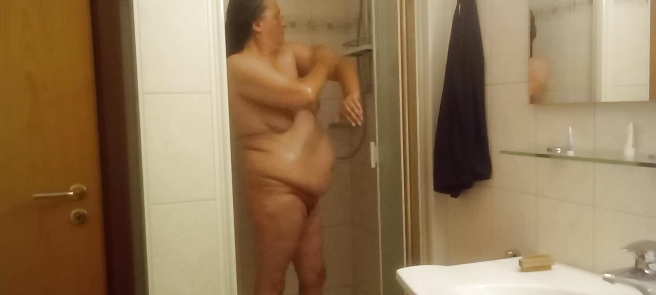 Mature chubby woman in the shower  big belly can be seen well