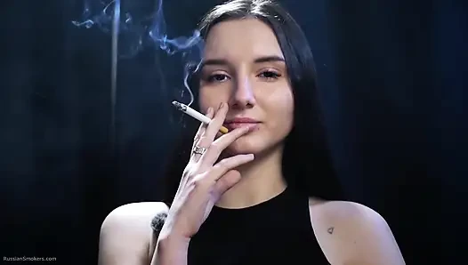 Elegant Brunette Smoking in Black Outfit