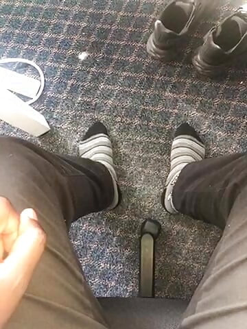 Young African feet out in socks in the office