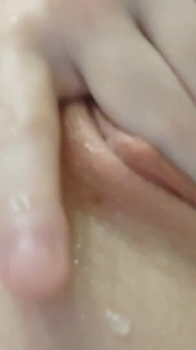A brunette plays with her pussy in the shower and it turns her on so much that she starts squirting. | Clip 1