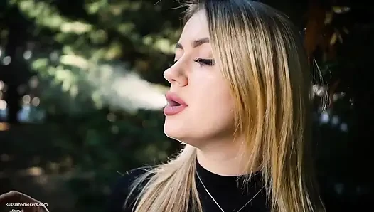 Hot Blonde Babe Smoking One Black Cigarettes in Nature