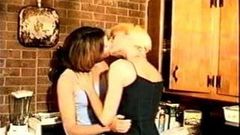 Lesbians French kissing in kitchen
